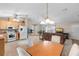 Open-concept view of the kitchen, dining area, and living room in a home with neutral tones and natural light at 1715 Queen Palm Dr, Edgewater, FL 32132