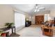 A bright living room with tile floors, large window, and a ceiling fan for added comfort at 1715 Queen Palm Dr, Edgewater, FL 32132