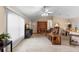 Bright living room with neutral tones, tile floors, and an open layout leading to the dining area at 1715 Queen Palm Dr, Edgewater, FL 32132