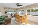 Bright sun room with tiled floors, ceiling fan, and lots of windows at 1715 Queen Palm Dr, Edgewater, FL 32132