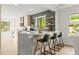 Kitchen featuring a marble island, stainless appliances, and stylish bar stool seating at 1841 Spruce Creek Blvd, Port Orange, FL 32128