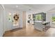 Open-concept kitchen with marble island, stainless appliances, and views of the front entrance at 1841 Spruce Creek Blvd, Port Orange, FL 32128