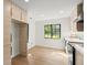 Modern kitchen with wooden cabinets, stainless steel appliances, and a window at 1841 Spruce Creek Blvd, Port Orange, FL 32128