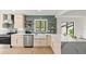 Modern kitchen with stainless steel appliances, stylish backsplash, and sleek countertops at 1841 Spruce Creek Blvd, Port Orange, FL 32128