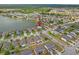 Aerial view of a lakefront home in a residential neighborhood, indicated by an arrow at 1929 Cove Point Rd, Port Orange, FL 32128