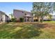 Fenced backyard with covered patio, lush lawn, and mature trees offering privacy at 1929 Cove Point Rd, Port Orange, FL 32128