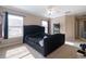Spacious bedroom features a tufted headboard, ceiling fan, and natural light from two windows at 1929 Cove Point Rd, Port Orange, FL 32128