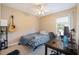 This bedroom has a ceiling fan, natural light and a desk for studying or working at 1929 Cove Point Rd, Port Orange, FL 32128