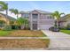Charming two-story home with a well-maintained yard, palm trees, and a two-car garage at 1929 Cove Point Rd, Port Orange, FL 32128