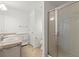 Updated bathroom with dual sinks, neutral paint, and a standing glass shower at 1930 Harston Trl, The Villages, FL 32162