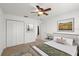Bright bedroom with neutral carpet, ceiling fan and closet space offers comfortable living at 1930 Harston Trl, The Villages, FL 32162