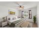 Bedroom with natural light, ceiling fan, accent rug, and tranquil window view creates inviting space at 1930 Harston Trl, The Villages, FL 32162