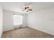 Bedroom features neutral carpet, ceiling fan, and window, providing a comfortable living space at 1930 Harston Trl, The Villages, FL 32162