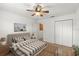 Bright bedroom with ceiling fan, en-suite and closet space offers comfortable living at 1930 Harston Trl, The Villages, FL 32162