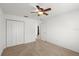 Bedroom features neutral carpet, ceiling fan and closet, offering comfortable living space at 1930 Harston Trl, The Villages, FL 32162