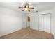 Bedroom features neutral carpet, ceiling fan and closet, offering comfortable living space at 1930 Harston Trl, The Villages, FL 32162