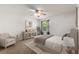 Bright bedroom with a ceiling fan, neutral carpet and paint, and tastefully staged furniture at 1930 Harston Trl, The Villages, FL 32162
