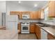 Cozy kitchen features updated appliances, cabinets, and countertops with a view to the exterior at 1930 Harston Trl, The Villages, FL 32162