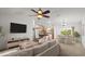 Bright, open-concept living space with views into the kitchen and dining area at 1930 Harston Trl, The Villages, FL 32162
