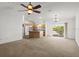 Spacious living area featuring carpet floors and sliding glass doors to the backyard at 1930 Harston Trl, The Villages, FL 32162