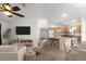 Inviting living and dining space with a kitchen island and plenty of natural light at 1930 Harston Trl, The Villages, FL 32162