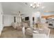 Inviting living and dining space with a kitchen island and plenty of natural light at 1930 Harston Trl, The Villages, FL 32162