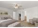 Bright main bedroom with a ceiling fan and easy access to closet and Primary bath at 1930 Harston Trl, The Villages, FL 32162