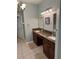 En suite bathroom featuring double sinks with granite countertops and updated fixtures at 201 Asterbrooke Dr, Deland, FL 32724