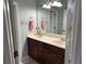 Bathroom with double sinks, large mirrors, and blue walls at 201 Asterbrooke Dr, Deland, FL 32724