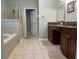 Spacious primary bath features a separate shower, soaking tub, and granite countertops at 201 Asterbrooke Dr, Deland, FL 32724
