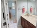 Bright bathroom features a double sink vanity with marble countertops and a separate toilet and shower area at 201 Asterbrooke Dr, Deland, FL 32724