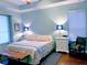 Bright and airy bedroom with tray ceilings, wood floors, and a queen-size bed at 201 Asterbrooke Dr, Deland, FL 32724