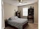 Bedroom with a decorative bed, bookshelf, and desk by a window at 201 Asterbrooke Dr, Deland, FL 32724