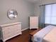 Bedroom featuring a large dresser and nightstand, with a mirror and window at 201 Asterbrooke Dr, Deland, FL 32724