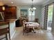 Charming dining area with a round table, chandelier, and convenient access to the kitchen and outdoor space at 201 Asterbrooke Dr, Deland, FL 32724