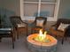 Outdoor firepit with blue glass stones and wicker chairs, perfect for cool nights at 201 Asterbrooke Dr, Deland, FL 32724