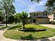 Charming two-story home featuring a well-manicured lawn, beautiful landscaping, and inviting curb appeal at 201 Asterbrooke Dr, Deland, FL 32724