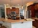 Open kitchen with granite countertops, stainless steel appliances, dark wood cabinets, and decorative pendant lighting at 201 Asterbrooke Dr, Deland, FL 32724