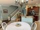 Spacious kitchen with dark wood cabinets, granite countertops, adjacent dining area, and a staircase nearby at 201 Asterbrooke Dr, Deland, FL 32724