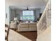 Comfortable living room with hardwood floors, ample seating, and a glimpse of the backyard and staircase at 201 Asterbrooke Dr, Deland, FL 32724