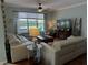 Inviting living room with neutral tones, stylish decor, hardwood floors, and a large window offering a view of the backyard at 201 Asterbrooke Dr, Deland, FL 32724