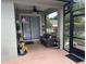 Relaxing screened in patio with comfortable seating, lush greenery, and ceiling fan at 201 Asterbrooke Dr, Deland, FL 32724