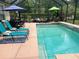 Relaxing screened in pool area with sun loungers, dining, and lounge seating at 201 Asterbrooke Dr, Deland, FL 32724