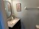 Stylish powder room with vanity, framed mirror, and decor at 201 Asterbrooke Dr, Deland, FL 32724