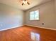 Bright bedroom featuring hardwood floors, a ceiling fan, and a window offering natural light at 206 Westmoor Bnd, Orlando, FL 32835