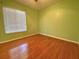 Cozy bedroom with hardwood floors, a ceiling fan, and a window with bright lighting at 206 Westmoor Bnd, Orlando, FL 32835