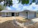 Charming single-story home with a gray exterior, walkway, and well-maintained landscaping at 206 Westmoor Bnd, Orlando, FL 32835