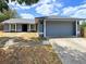 Charming single-story home featuring a two-car garage and well-maintained lawn at 206 Westmoor Bnd, Orlando, FL 32835