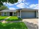 Charming single-Gathering home featuring a well-maintained lawn, a gray exterior and a two-car garage at 206 Westmoor Bnd, Orlando, FL 32835