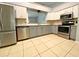 Well-lit kitchen featuring stainless steel appliances, granite countertops, and gray and white cabinetry at 206 Westmoor Bnd, Orlando, FL 32835
